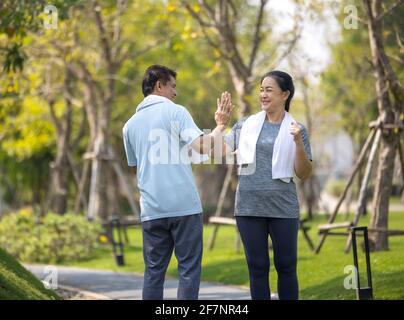 Smiling senior couple jogging , Senior couple jogging and running in the park outdoors nature Stock Photo