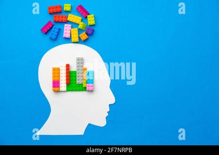 Papercut silhouette of human head with colorful constructor pieces Stock Photo