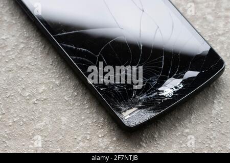 The LG logo is seen on a cracked smartphone on April 8, 2021. LG Electronics has confirmed its rumored exit from the competitive smartphone industry. Stock Photo