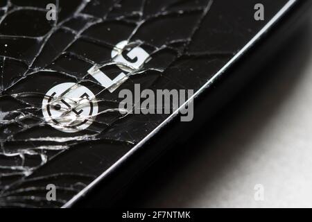 The LG logo is seen on a cracked smartphone on April 8, 2021. LG Electronics has confirmed its rumored exit from the competitive smartphone industry. Stock Photo