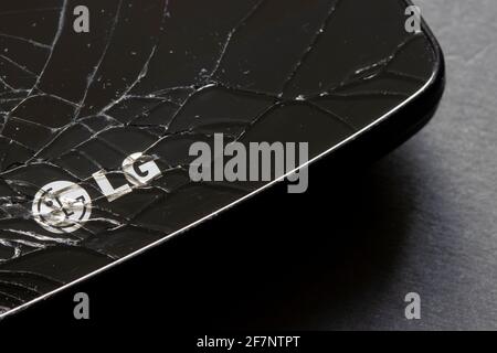 The LG logo is seen on a cracked smartphone on April 8, 2021. LG Electronics has confirmed its rumored exit from the competitive smartphone industry. Stock Photo