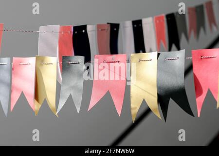 Decorations from flags for the holiday. Color gold, pink blak. Stock Photo