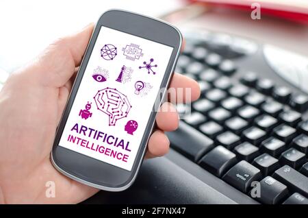 Hand holding a smartphone showing an artificial intelligence concept Stock Photo