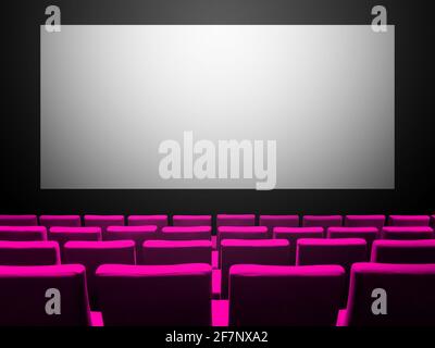 Cinema movie theatre with pink velvet seats and a blank white screen. Copy space background Stock Photo