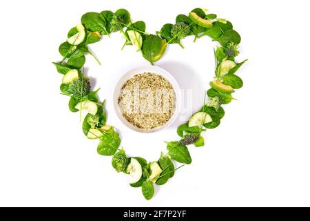 Heart Shape green Detox Salad and Vegetables with Hemp Seeds isolated on white Background Stock Photo