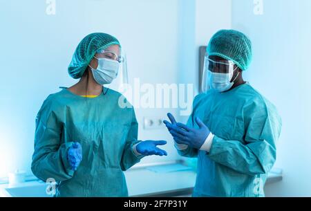 Doctors wearing personal protective equipment fighting against corona virus outbreak - Health care and medical workers concept Stock Photo