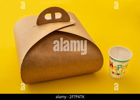 Packaging box with handle mockup for cake and birthday paper cup on yellow background Stock Photo