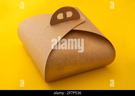 Packaging box with handle mockup for cake on yellow background Stock Photo
