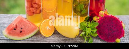 BANNER, LONG FORMAT Cambucha with various fruits arranged in the form of a rainbow. Homemade fermented raw kombucha tea with different flavorings Stock Photo