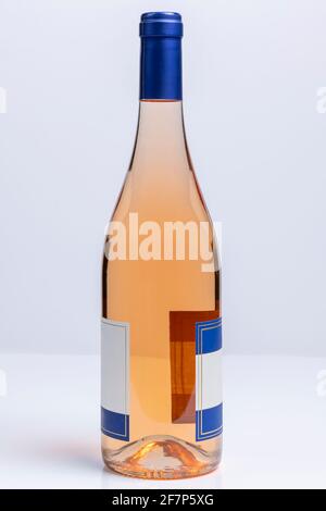 Beautiful burgundy style bottle of pinot grigio wine on white surface and background Stock Photo