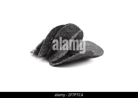Black potato chips isolated on white background. Beer snack Stock Photo