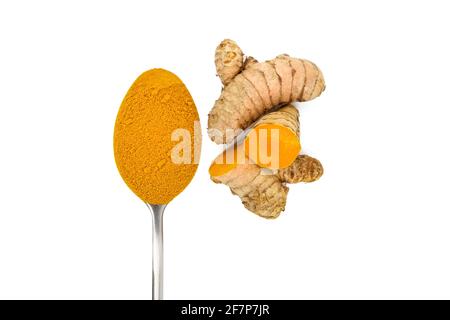 Curcuma roots and powder in spoon isolated on white background, top view. Halved turmeric rhizome. Oriental spice Stock Photo
