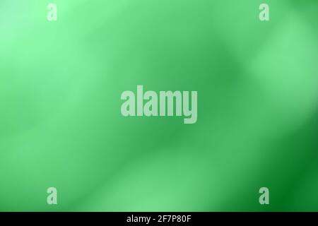 Blurred green and emerald background. Defocused art abstract olive gradient backdrop with blur and bokeh. Blurry wallpaper. Stock Photo