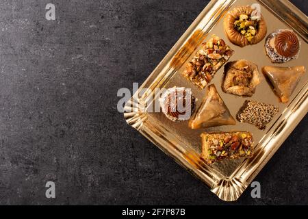 Assortment of Ramadan dessert baklava on black slate background Stock Photo