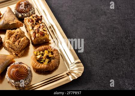Assortment of Ramadan dessert baklava on black slate background Stock Photo