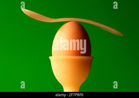 boiled breakfast egg with an egg spoon in an egg cup Stock Photo