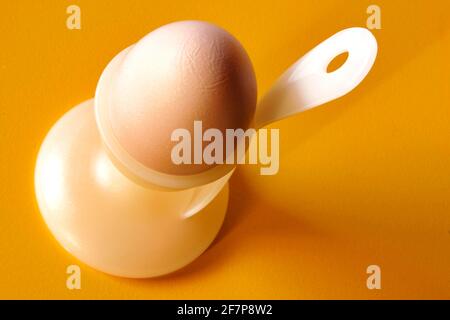boiled breakfast egg with an egg spoon in an egg cup Stock Photo