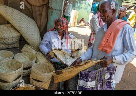 Koraput, India - February 2021: Men buying cane baskets in the Koraput market on February 21, 2021 in Odisha, India. Stock Photo