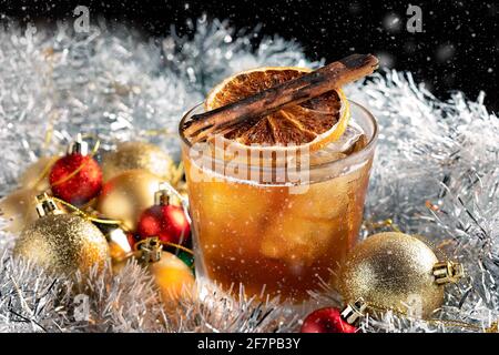 Special Christmas cocktail served on ice in a rock glass with Christmas decorations. Stock Photo