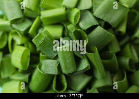 Chopped green onion on whole background, close up Stock Photo