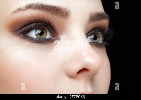 Closeup macro shot of human female face. Woman with natural face and eyes beauty makeup. Stock Photo
