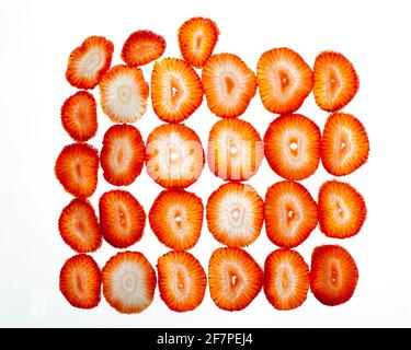 Slices of strawberries macro. Isolated on white background. Flat lay, top view. Stock Photo