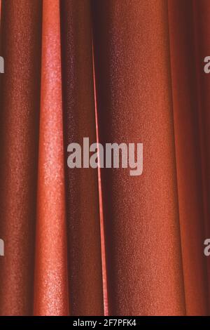 Full frame of red folded silk velvet fabric as background, vertical lines. Background fod desing Stock Photo