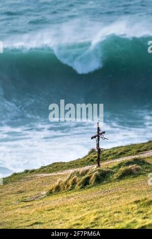 A small iron memorial cross on Towan Head overlooking the sea in Newquay in Cornwall. Stock Photo
