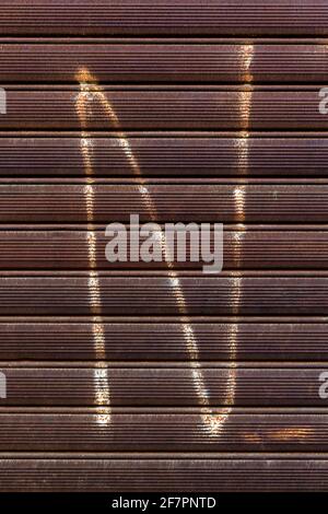 Graffiti of a letter N on rusted metal gate Stock Photo