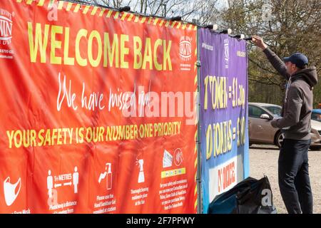 London, UK. 9th Apr, 2021. 'Welcome Back' says the sign as a funfair worker puts up lights in preparation for reopening which will be allowed on Monday 12 April. Credit: Anna Watson/Alamy Live News