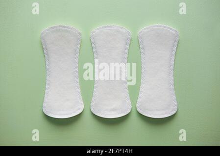 Three pads for women on a blue background. Stock Photo