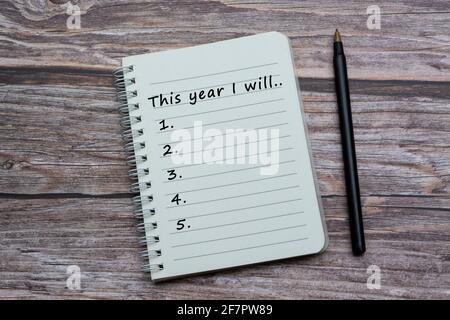 Text on notebook with pen on wooden desk Stock Photo