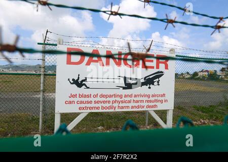 Beach spectator jet blast warning sign at the Maho Beach end of Juliana International Airport runway St Maarten Stock Photo