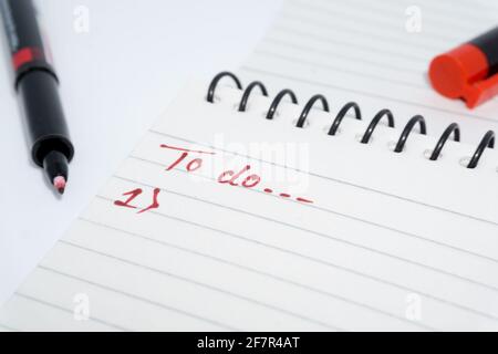 A hand written TO-DO list on a white paper with red marker. Stock Photo