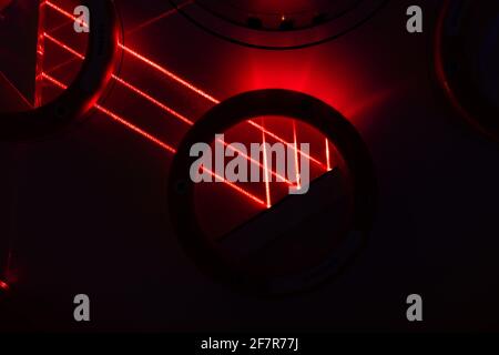 Dark street, reflection of neon light on wet asphalt. Rays of light and red laser light in the dark. Night view of the street, the city. Abstract dark Stock Photo