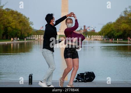 Washington, USA. 08th Apr, 2021. Looking ahead to post-pandemic days, a couple practices their dance moves by the Reflecting Pool of the Lincoln Memorial in Washington DC on April 8, 2021. (Photo by Tony Peltier/Sipa USA) Credit: Sipa USA/Alamy Live News Stock Photo