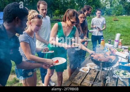 PRAGUE, CZECH REPUBLIC - JUNE 5, 2016: International students of Charles University during a barbecue party in Stromovka park. Stock Photo