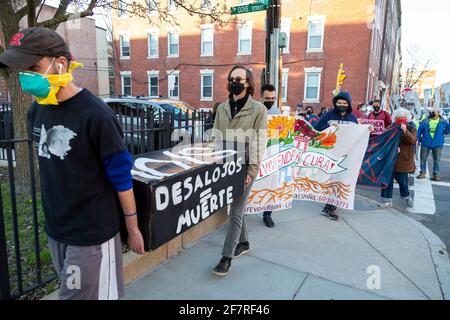 April 8, 2021. East Boston, MA. Marchers gathered in front of 168 Gove St. in East Boston, Massachusetts, an apartment building where Latinx immigrant Stock Photo