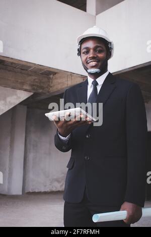 African engineer manager architect looking at construction project with using tablet Stock Photo