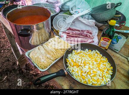Typical preparations for a lunch in the mountains. Tomato sauce, homemade pasta, boiled eggs, grilled meat. Abruzzo, Italy, Europe Stock Photo