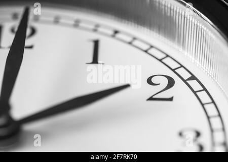 Clock hand pointing two o'clock on white clock face of Twin bell classic alarm clock Stock Photo