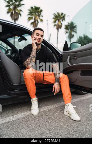 Young Man Poses With His Car. Stock Photo, Picture and Royalty Free Image.  Image 130497369.
