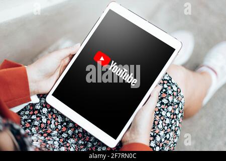Podolsk, Ukraine - March 29, 2021: Woman watching Youtube app website on digital tablet. Stock Photo