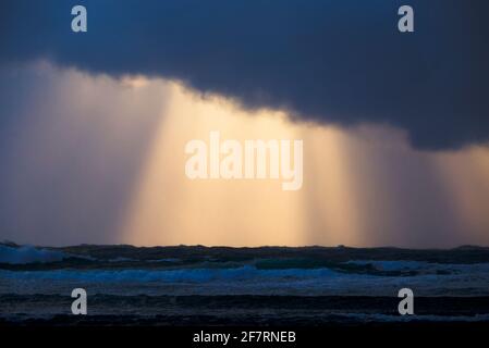 Crepuscular rays and storm clouds over the sea Stock Photo