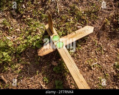 A broken footpath sign in the country laying on the ground Stock Photo