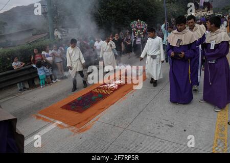 Intricate and vibrant sawdust alfombras decorate the cobblestone streets of Antigua, Guatemala in preparation for the Semana Santa processions. Stock Photo