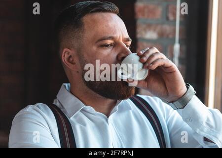 Young businessman drinking espresso coffee in a cafe Stock Photo