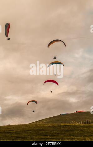 Mount Caburn, Lewes, East Sussex, UK. 9th Apr, 2021. Wind from the South West brings paraglider pilots to Mount Caburn, East of Lewes in the Sussex downs. Credit: David Burr/Alamy Live News Stock Photo