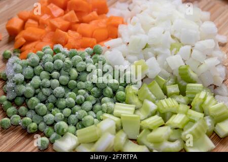 Selection of Fresh and Frozen chopped vegetables on a cutting board Stock Photo
