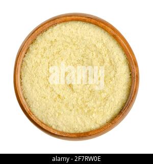 Instant mashed potatoes, in a wooden bowl. Dehydrated potato flakes. Cooked, then mashed, dehydrated and flaked potatoes. Convenience food. Stock Photo